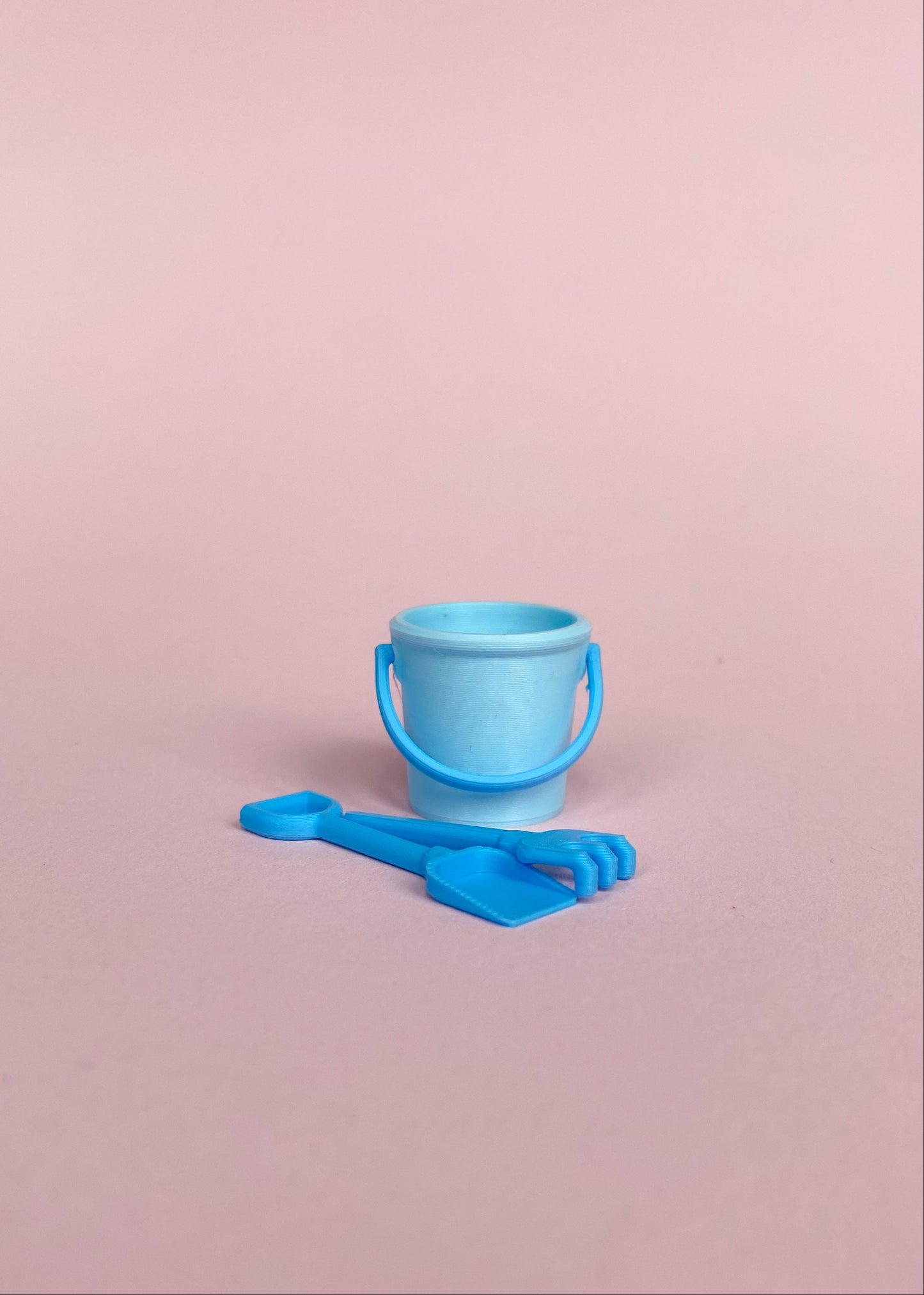 Miniature bucket, little shovel and rake.