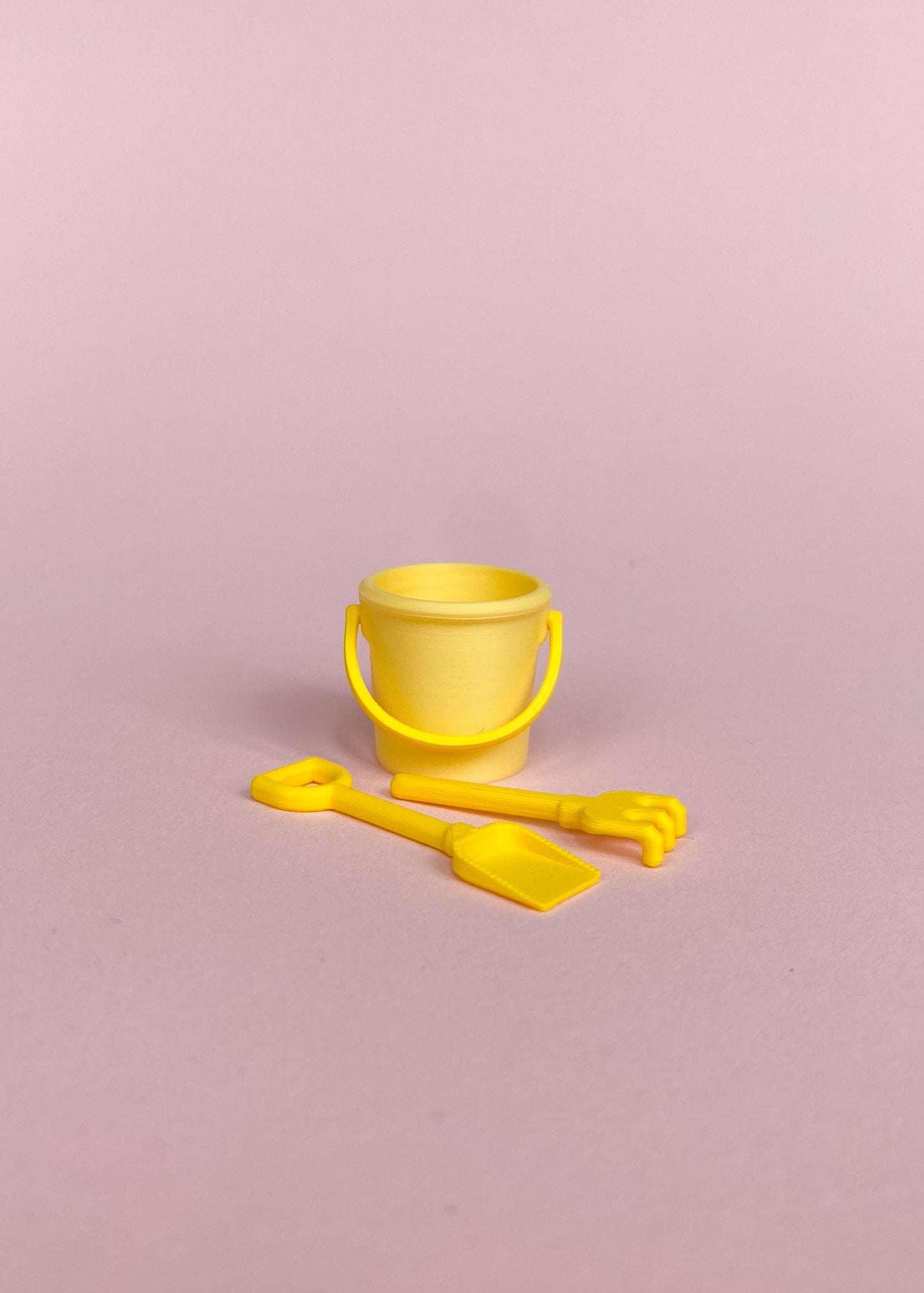 Miniature bucket, little shovel and rake.